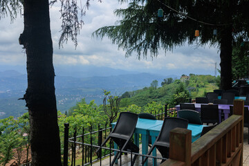 Wall Mural - Beautiful views from above, tables in a cafe in the mountains and a panoramic view of the city, public places in Turkey, on a sunny summer day