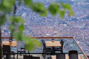 Wall Mural - Beautiful views from above, tables in a cafe in the mountains and a panoramic view of the city, public places in Turkey, on a sunny summer day