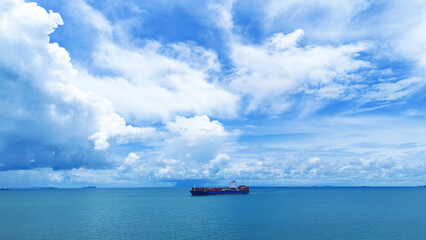 Side Cargo container ship on beautiful sky cloud carrying container and running out international container port customs shipyard sea port concept smart logistic