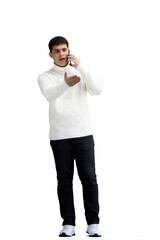 Wall Mural - A man, full-length, on a white background, talking on the phone