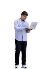 Wall Mural - A man, full-length, on a white background, uses a laptop