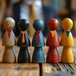© Mind - A diverse group of business professionals wearing ties of different colors stand together on a wooden table.