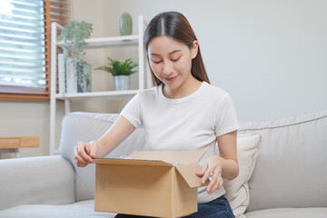 person unboxing package shopping online via internet at home