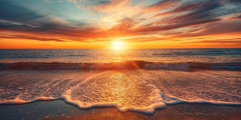 A breathtaking sunset over the ocean with vibrant colors and gentle waves washing onto the sandy beach