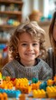 © VISUAL BACKGROUND - Child playing with colorful cubes.