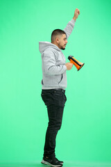 Canvas Print - A man, full-length, on a green background, with a megaphone