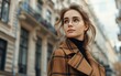 © imagineRbc - Young woman wearing glasses standing in front of a building, looking straight ahead