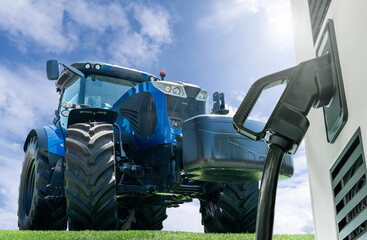 Poster - Electric vehicles charging station on a background of agricultural tractor. Concept