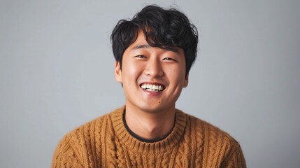 Wall Mural - Portrait of a fictional young Korean man happy and smiling. Isolated on plain background