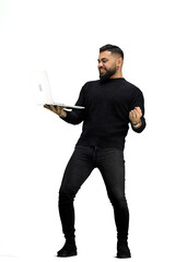 Wall Mural - A man, in full height, on a white background, uses a laptop