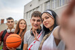 © Miljan Živković - group of teenage students self portrait selfie of gen z sit in campus
