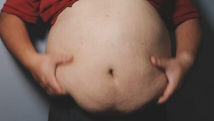 Overweight man's belly,fat man has excess fat, he is dieting and losing weight.unhealthy,medical health concept with copy space space for text