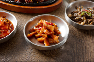 A view of banchan dishes, featuring eomuk bokkeum.