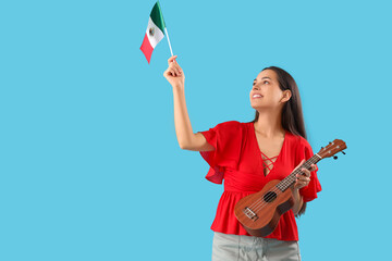 Wall Mural - Young woman with Mexican flag and guitar on blue background