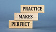 © Zhanna - PRACTICE MAKES PERFECT - words on wooden blocks on blue background