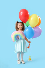 Canvas Print - Cute little girl with balloons and toy rainbow on blue background