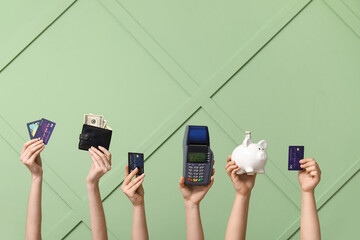 Poster - Female hands with credit cards, wallet, piggy bank and payment terminal on green background