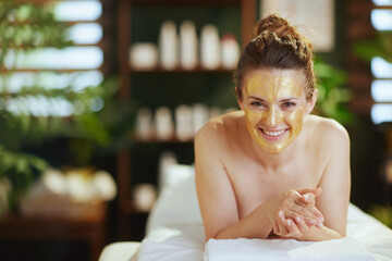 Wall Mural - happy modern female in massage cabinet laying on massage table