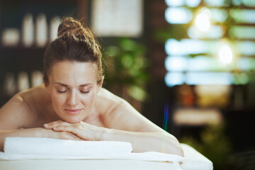 Poster - relaxed modern woman in spa salon laying on massage table