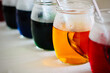 © RooM The Agency - Close-up of a row of glass jars filled with multi coloured dye for dying Easter Eggs