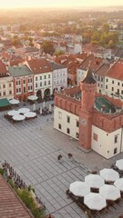 Wall Mural - Aerial view of Tarnow old town at sunrise, Poland. Drone footage of the Tarnow cityscape with Cathedral Church of Holy Family, Rynek square with Town Hall and historic buildings at sunny morning.