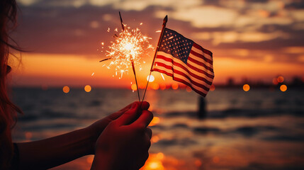 Sparkler and American flag in the sunset