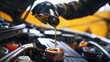 © Nany - man mechanic pouring oil in the car engine