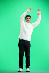 Wall Mural - A man, full-length, on a green background, waving his arms