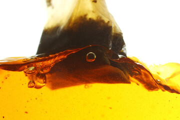 Poster - Close up shot of steeping tea bag in hot water