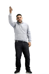 Canvas Print - A man, full-length, on a white background, waving his phone