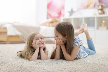 Poster - Cute little sisters on floor at home