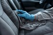 © LimeSky - Commercial cleaning company professionally cleans gray textile back passenger seat using extraction method with protective glove Regularly clean auto interior