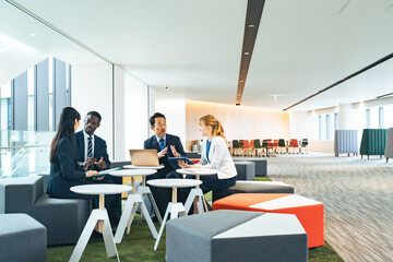 Poster - Group of multinational business people talking in a lobby