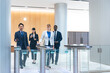 © metamorworks - Group of multinational business people passing through a security gate