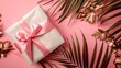 © kitipol - A gift box with a decorative ribbon bow, set on a flat lay solid color background with dried flowers and tropical leaves, featuring ample area for copy