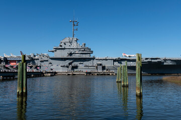 CHARLESTON, SC, USA - March 29, 2024: USS Yorktown in dry dock showing midship section with aircraft and people touring the deck. 