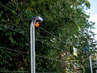 Red warning light bulb installed on light poles on wire electric fence that separates homes from the forest for safety purposes. Prevent animals or people from invading case.