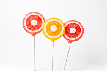 Canvas Print - Three lollipops with different colors and flavors, isolated on a white background