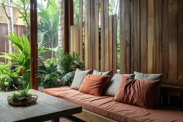 Wall Mural - Modern tropical interior design featuring cushion sofa plant on table wooden wall and garden