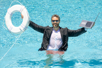 Helping businessman. Businessman in suit hold laptop and lifebuoy in sea beach water. Rescue businessman. Helping businessman. Save and help business. Support businesses owner.