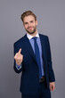 © be free - Rude businessman show middle finger. Businessman in suit shows an indecent gesture isolated on grey. Arrogant lawyer man with middle finger. Business man show offensive gesture