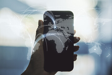 Wall Mural - double exposure of abstract digital world map with connections and hand with cell phone on backgroun