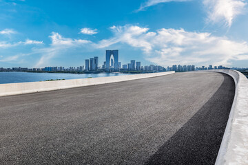 Wall Mural - Empty asphalt road and modern city skyline in Suzhou