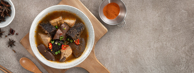 Wall Mural - Spicy duck blood jelly soup and stinky tofu with scallion and chili pepper topping.