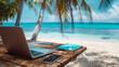 © Rodolphe - laptop on a wooden table on tropical beach - travel work concept