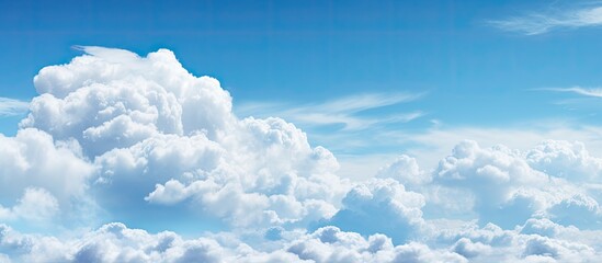 Wall Mural - The clear blue sky featuring fluffy white clouds creates a perfect copy space image