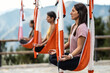 © Westend61 - Women with eyes closed meditating on aerial silk practicing yoga in class