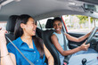 © Westend61 - Happy young woman driving car sitting with friend