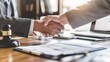 © saritwat - Close-up of two business people shaking hands lawyer