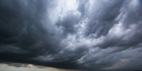 Aufkleber - Bad or moody weather sky and environment. carbon dioxide emissions, greenhouse effect, global warming, climate change. The dark sky with heavy clouds converging and a violent storm before the rain.